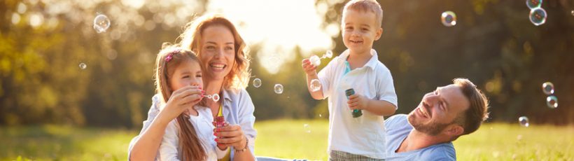 Family with children blow soap bubbles